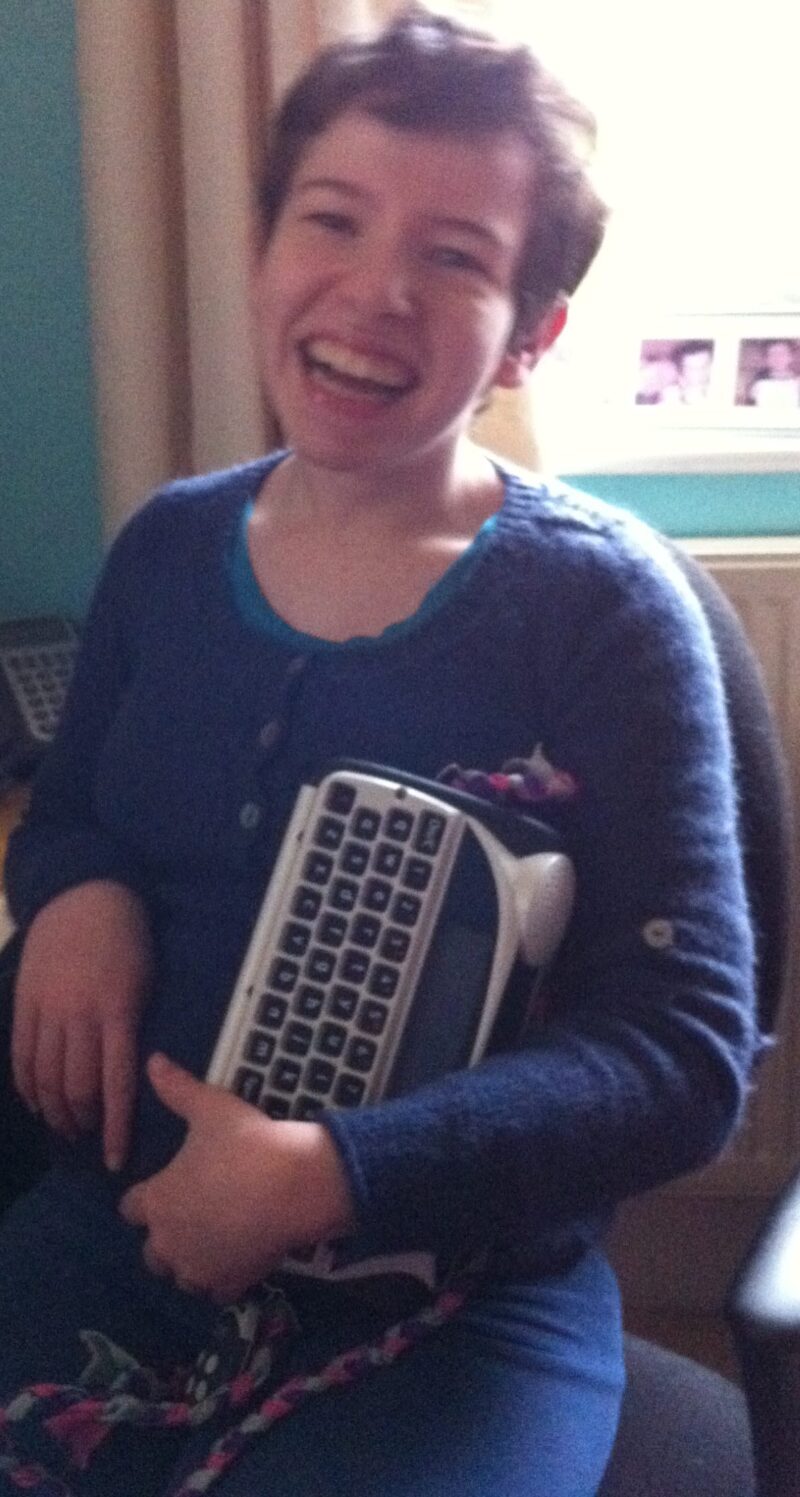 Beth Moulam holding lightwriter, AAC device with British Acapela voice Lucy