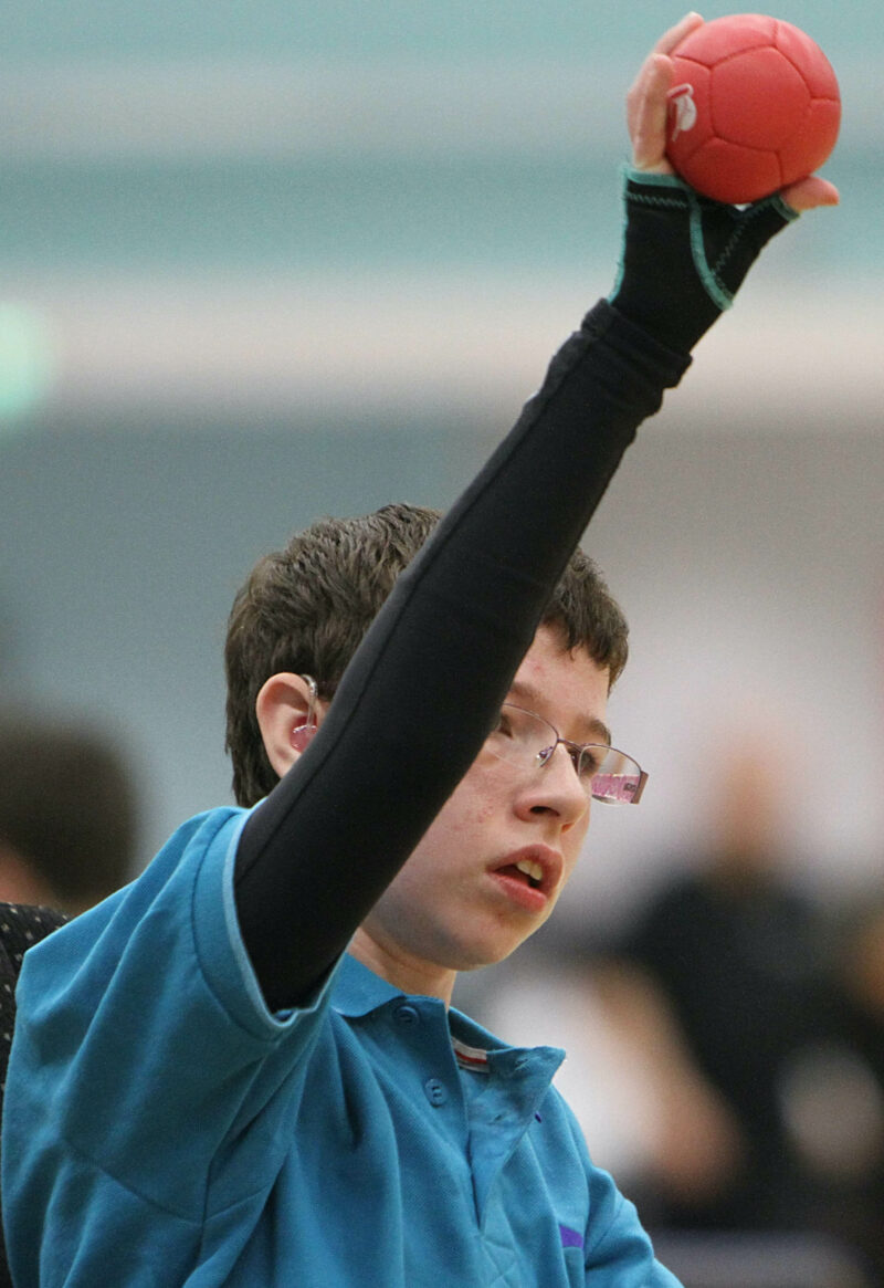 cerebral palsy, boccia player wearing skins and gauntlet to throw ball