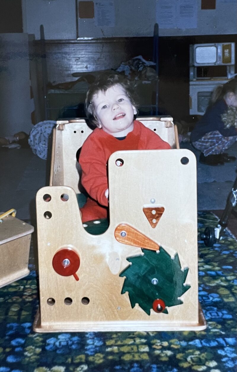Beth Moulam, young child at pre-school nursery sat in a box
