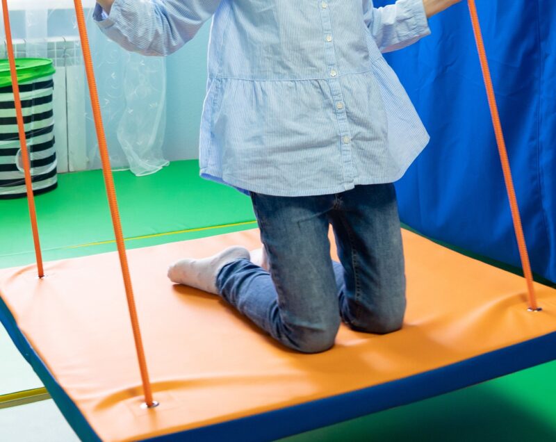 girl on platform swing, with CP, have a go attitude, life is an adventure