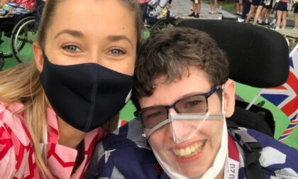 Beth Moulam, boccia athlete at closing ceremony Tokyo 2020 with Christie Hutchings sports assistant. Wearing red and blue GB kit and masks.