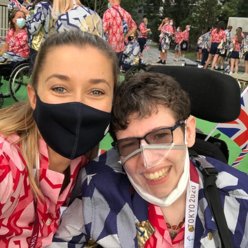 Beth Moulam, boccia athlete at closing ceremony Tokyo 2020 with Christie Hutchings sports assistant. Wearing red and blue GB kit and masks.