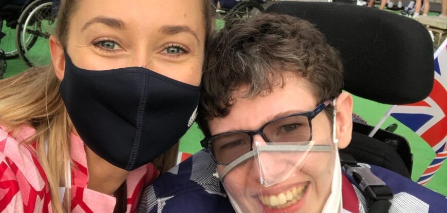 Beth Moulam, boccia athlete at closing ceremony Tokyo 2020 with Christie Hutchings sports assistant. Wearing red and blue GB kit and masks.