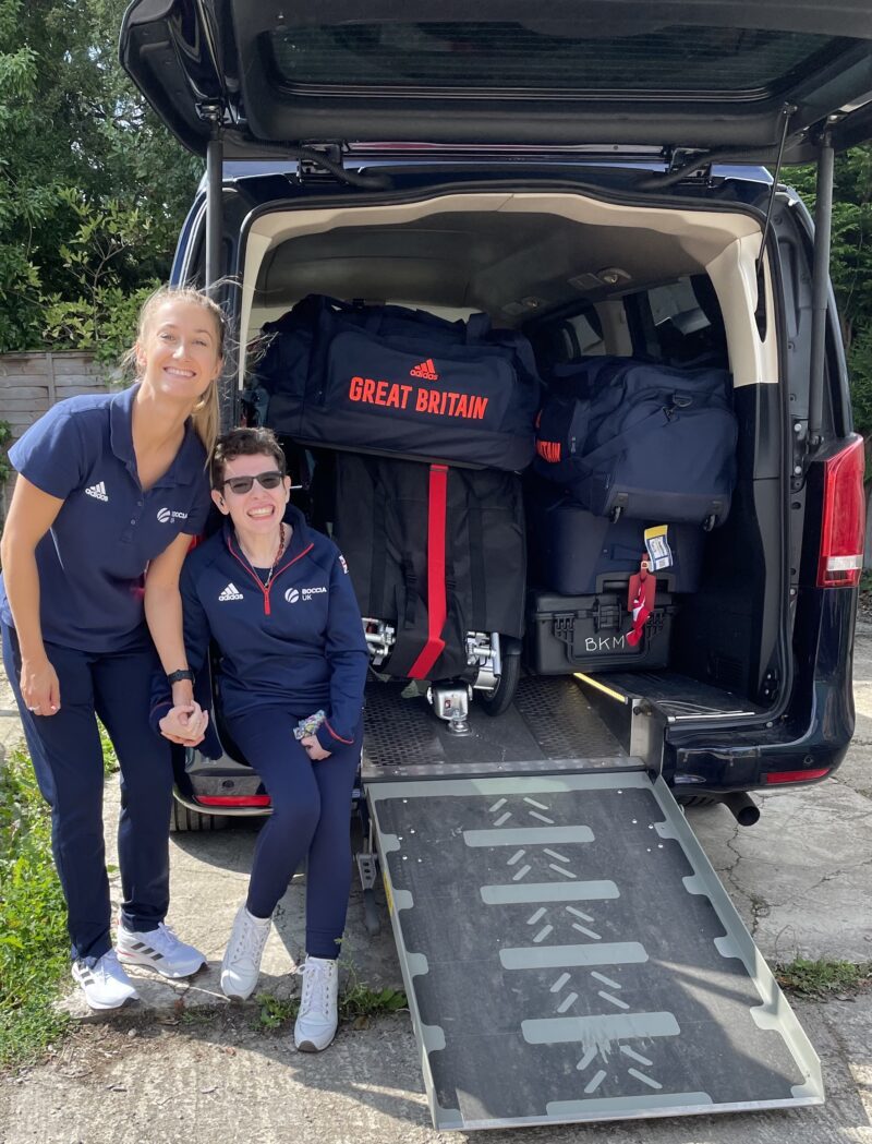 Two females sat rear of van full of sports equipment