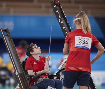 Beth Moulam with CP, playing boccia with ramp supported by sports assistant. Tokyo 2020 paralympics