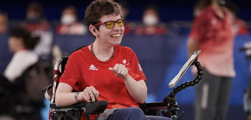 Beth Moulam, female with CP, BC3 boccia athlete. Wearing red GB sports kit