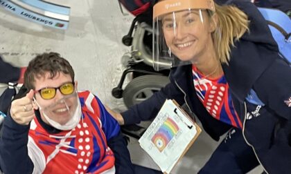 Beth Moulam BC3 boccia athlete and Christie Hutchings Ramp Operator. Wearing sports kit and clear lip reading masks. Beth with thumbs up, showing delight qualified for the BC3 individual semi-finals.