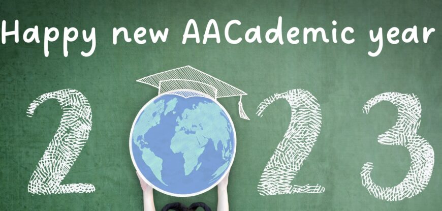 Happy new AACademic year 2023. the 0 is a globe held in the air with a teachers hat on top. The background is dark green and the writing white chalk.